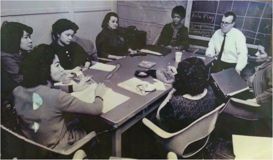 mary-dowery-and-frank-riessman-at-the-end-of-the-table-lead-a-role-playing-session-for-lower-east-side-parents-1963-or-1964