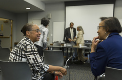 Photograph of Daryl Sherman (l) and Sheryl Harrison (r) in conversation at Modern School multigenerational reunion