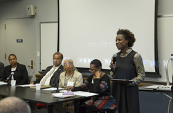 Photograph of Tina Campt greeting participants at Modern School multigenerational reunion