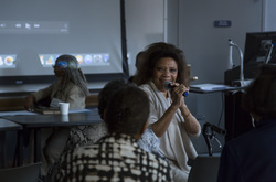 Photograph of Cherilyn (Liv) Wright speaking at Modern School multigenerational reunion