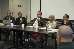 Photograph of Bruce North speaking on the panel at Modern School multigenerational reunion
