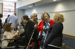 Photograph of Patricia Hayes in conversation at Modern School multigenerational reunion