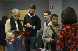 Photograph of Modern School alumna Shirley Ferguson Godfrey (l) sharing archival material with Teachers College students John Fleming (center) and Barry Goldenberg (right)